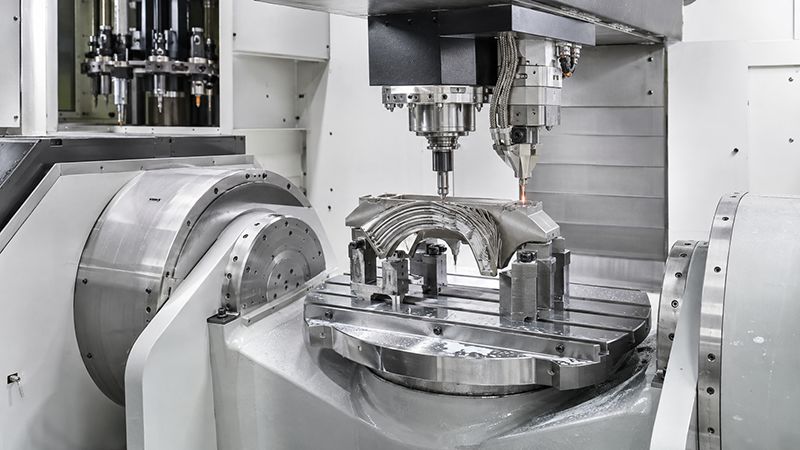 Hybrid manufacturing machine combining metal additive deposition and CNC machining